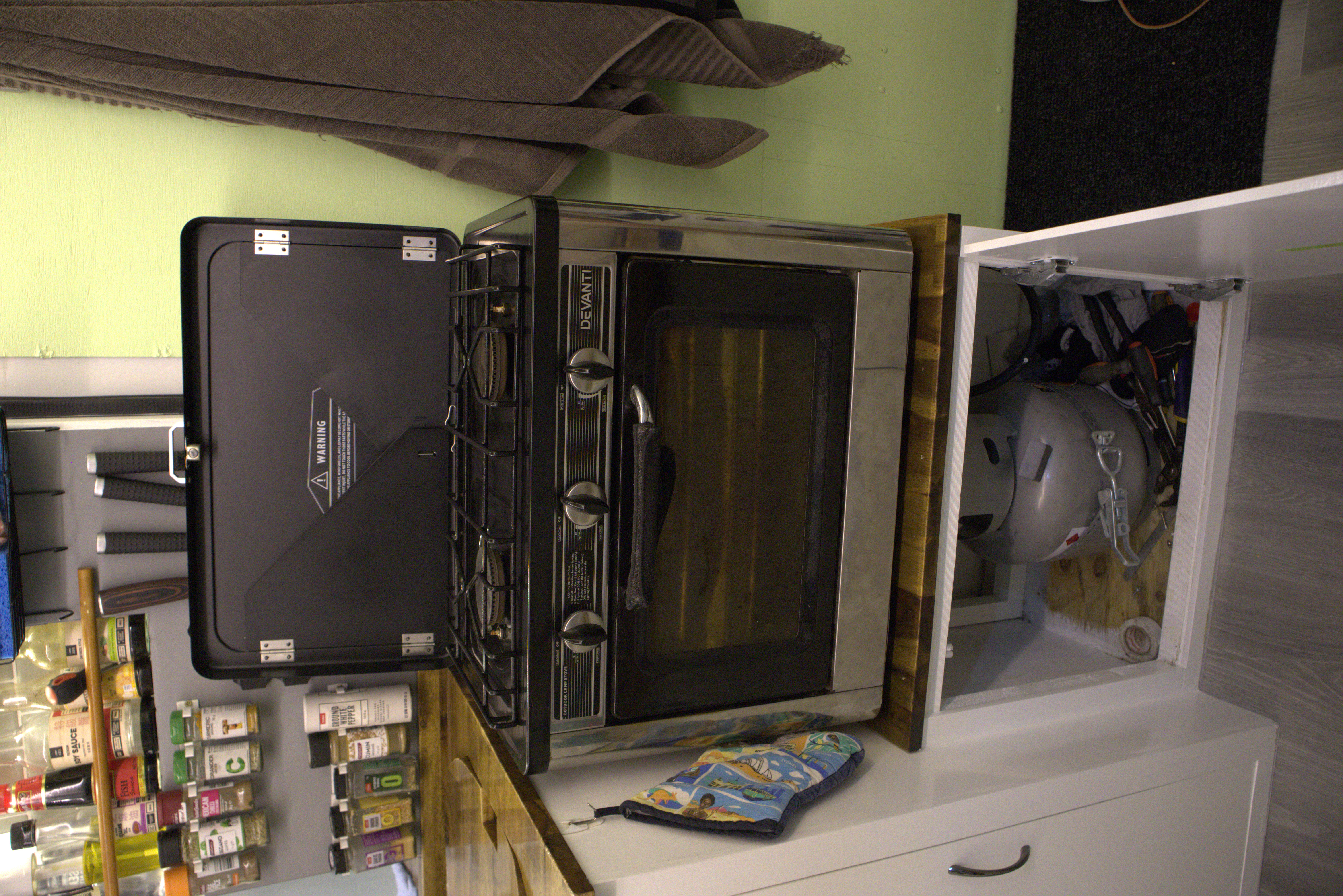 Portable gas oven and hob in van kitchen